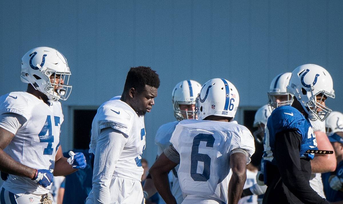 NFL players in practice jerseys during a training camp session