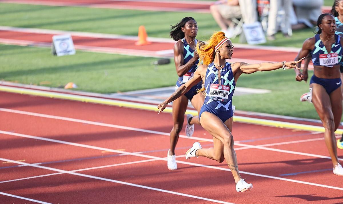 Sha’Carri Richardson sprinting across the finish line on a track