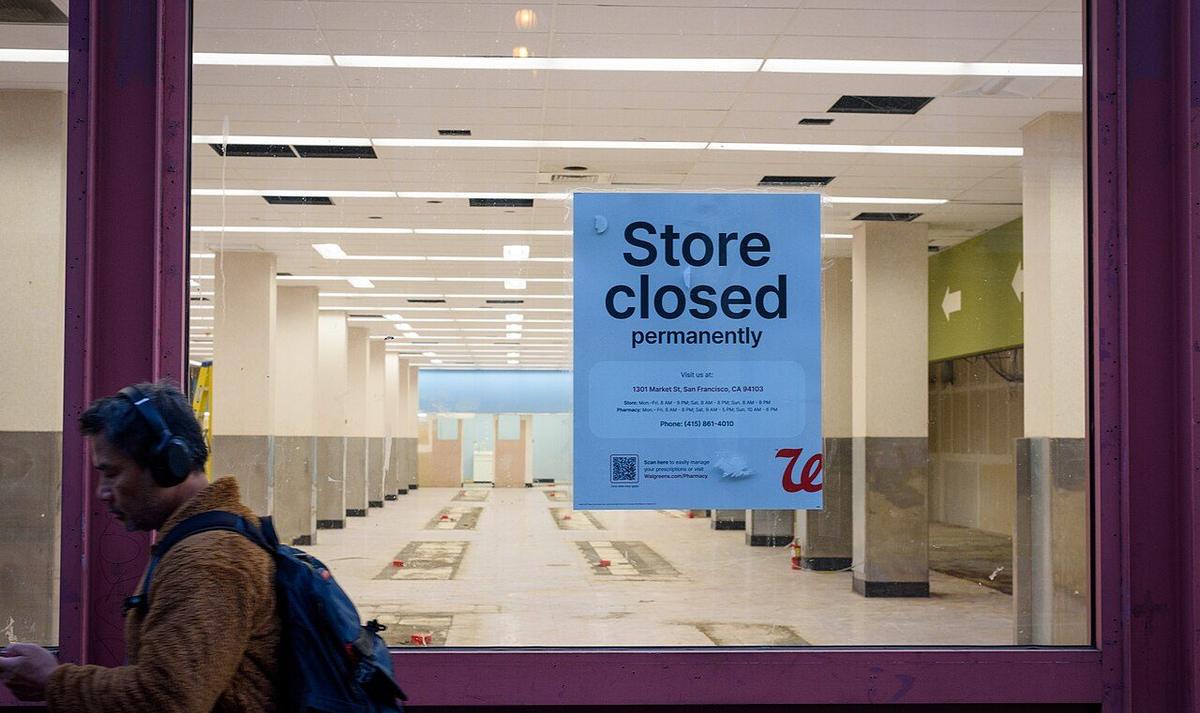 A permanently closed Walgreens store with a notice in the window